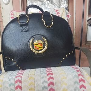 Black leather with gold accents weekender bag